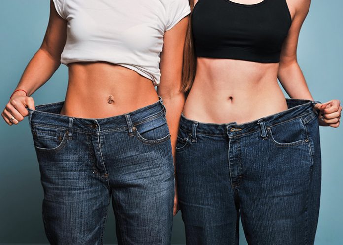 Two fit women in loose jeans