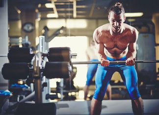 How To Increase your Fitness Program Efficiency? Fit sportsman lifting weight