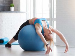 Fit sportswoman doing pilates with stability ball