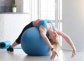 Fit sportswoman doing pilates with stability ball